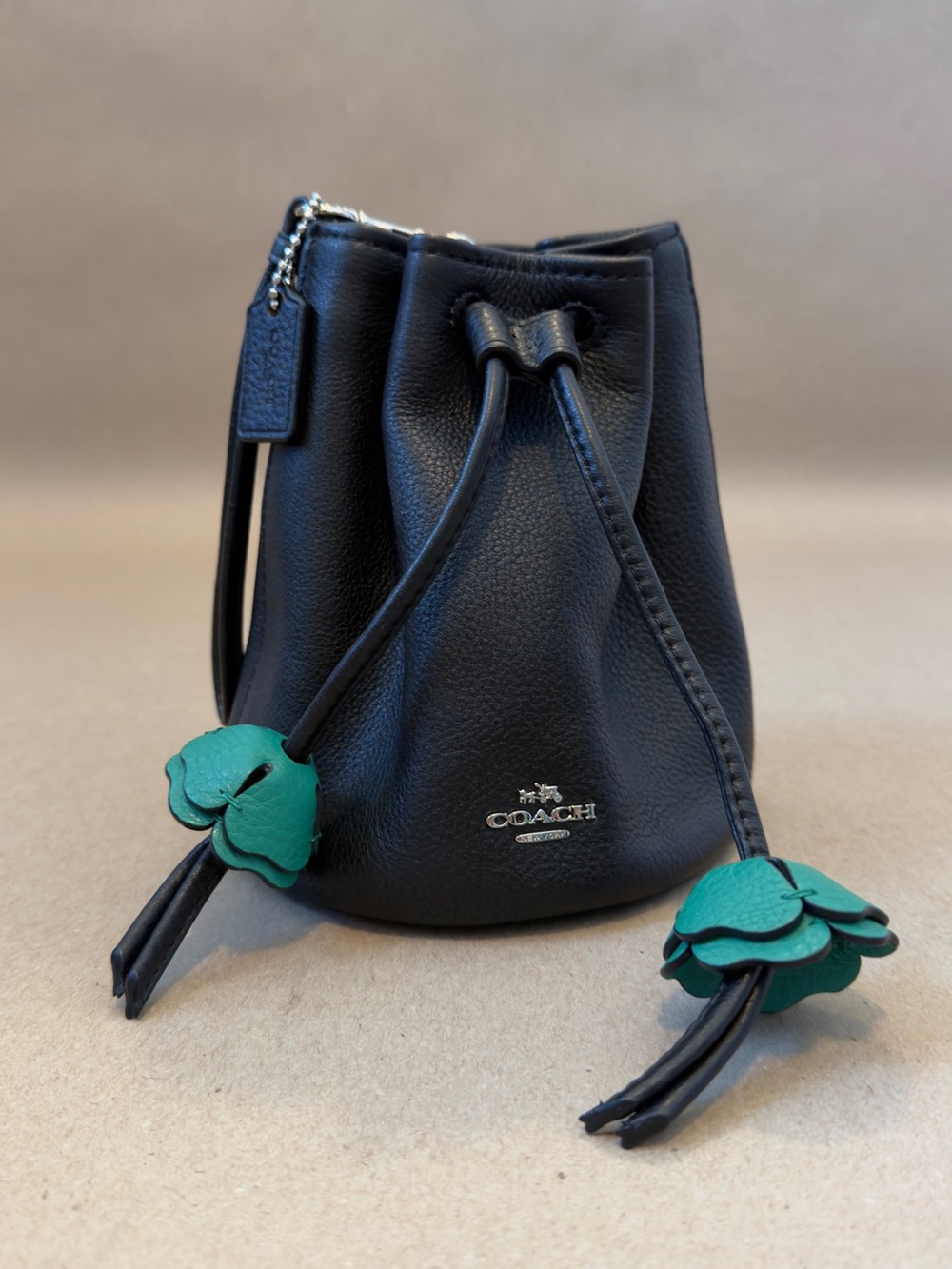 Coach Black Pebbled Leather Mini Drawstring Bucket Bag with Green Flower Charms